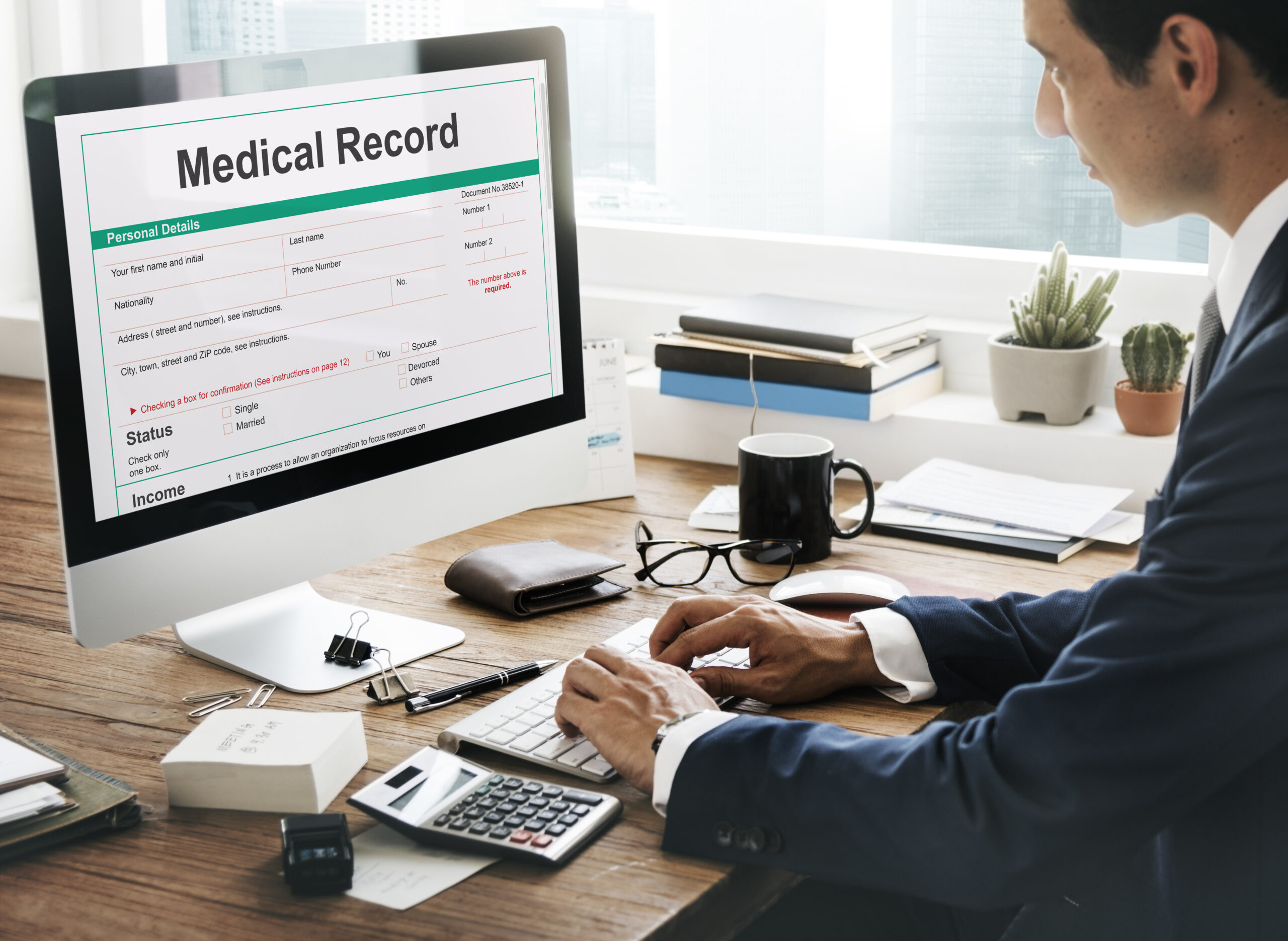 a guy is checking medical record on computer screen