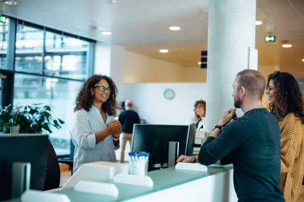 receptionist is talking with a couple in dental clinic